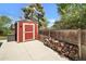 Outdoor shed featuring wood storage with a small fenced area at 8065 W Fremont Dr, Littleton, CO 80128