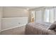 Spacious bedroom with neutral carpet and paint, open layout and access to ensuite bath and balcony at 13635 E Yale Ave # D, Aurora, CO 80014