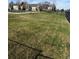 Large community lawn adjacent to pool is surrounded by secure fencing and mature landscaping at 13635 E Yale Ave # D, Aurora, CO 80014