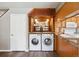 Convenient laundry area with modern washer and dryer, situated near kitchen and a door to another room at 13635 E Yale Ave # D, Aurora, CO 80014
