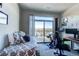 Cozy bedroom with exercise equipment, a large window, and a view of the outdoors at 155 S Monaco Street Pkwy # 311, Denver, CO 80224