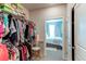 Walk-in closet leading to bedroom with neat shelves and well-organized clothes at 155 S Monaco Street Pkwy # 311, Denver, CO 80224