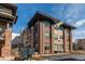 Modern building exterior with brick accents and well-maintained landscaping at 155 S Monaco Street Pkwy # 311, Denver, CO 80224