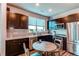 Modern kitchen with wood floors, stainless steel appliances, and a cozy breakfast nook at 155 S Monaco Street Pkwy # 311, Denver, CO 80224