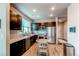 Bright kitchen with stainless steel appliances, dark cabinets, and a round dining table at 155 S Monaco Street Pkwy # 311, Denver, CO 80224