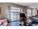 Stylish living room with a view to the balcony, comfortable sofas, and a wooden table at 155 S Monaco Street Pkwy # 311, Denver, CO 80224