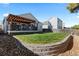 Exterior view of the home's backyard with a well-kept lawn, patio area, and a privacy fence at 5611 S Sicily Cir, Aurora, CO 80015