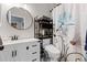 Clean bathroom with white vanity, floral shower curtain, and neutral wall color at 5611 S Sicily Cir, Aurora, CO 80015