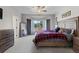 Spacious bedroom featuring a wooden bed frame, dresser, mirror and lots of natural light at 5611 S Sicily Cir, Aurora, CO 80015