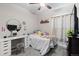 Bright bedroom with carpet, white walls, and simple decor, featuring desk and chair at 5611 S Sicily Cir, Aurora, CO 80015