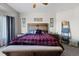 A comfortable bedroom features a wooden bed frame and a red and black plaid comforter at 5611 S Sicily Cir, Aurora, CO 80015