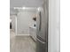 Bright kitchenette with stainless steel appliances, light cabinets, and wood-look flooring at 5611 S Sicily Cir, Aurora, CO 80015