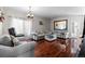 Cozy living room featuring hardwood floors, ample seating, and a large mirror reflecting natural light at 5611 S Sicily Cir, Aurora, CO 80015
