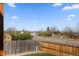 Scenic street view with mature trees and distant mountain views from the property at 5611 S Sicily Cir, Aurora, CO 80015