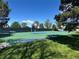 Outdoor basketball court featuring green surface, hoops, and court markings in a recreational area at 7035 E 38Th Ave # 4, Denver, CO 80207