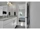 Modern bathroom with double sink vanity, modern fixtures, and view into bedroom at 7035 E 38Th Ave # 4, Denver, CO 80207