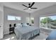 Bright bedroom featuring three windows, neutral walls, ceiling fan and modern furniture at 7035 E 38Th Ave # 4, Denver, CO 80207