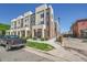 Modern townhome exterior featuring brick accents, neutral siding, and manicured landscaping, offering curb appeal at 7035 E 38Th Ave # 4, Denver, CO 80207