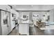 Open-concept kitchen with white cabinets, stainless appliances, and large island flowing into the living area at 7035 E 38Th Ave # 4, Denver, CO 80207