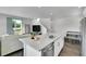Contemporary kitchen with an island, stainless steel dishwasher, and an open view to the living area at 7035 E 38Th Ave # 4, Denver, CO 80207