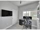Bright office featuring closet, large window and neutral walls, and a large screen tv at 7035 E 38Th Ave # 4, Denver, CO 80207