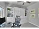 Bright office area featuring built-in shelving and desk, with a Murphy bed at 7035 E 38Th Ave # 4, Denver, CO 80207