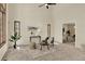 Bright living room with high ceilings, a ceiling fan, and abundant natural light from multiple windows at 70 Long Bow Cir, Monument, CO 80132