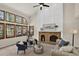 Cozy living room with a brick fireplace, large windows, and comfortable seating at 70 Long Bow Cir, Monument, CO 80132