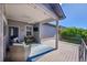 Cozy covered back deck with lounge seating, ceiling fan, and string lights at 6632 Osage St, Denver, CO 80221