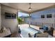 Back deck with a mounted TV, string lights, modern railings and outdoor seating at 6632 Osage St, Denver, CO 80221