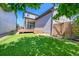 Backyard featuring synthetic grass and a wooden fence with a gate at 6632 Osage St, Denver, CO 80221