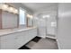 Bathroom featuring double sinks, granite countertop, a large glass shower, and tile flooring at 6632 Osage St, Denver, CO 80221