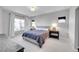 Spacious bedroom with a large window, soft carpet, and a comfortable king-sized bed at 6632 Osage St, Denver, CO 80221