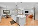 Spacious kitchen with an island providing seating, open to the living and dining areas, and hardwood floors at 6632 Osage St, Denver, CO 80221