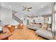 Open-concept living space with wood floors, neutral decor, and a staircase leading to the upper level at 6632 Osage St, Denver, CO 80221
