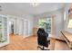 Bright home office with hardwood floors, French doors, and a large window offering natural light at 6632 Osage St, Denver, CO 80221