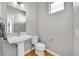 Powder room featuring modern fixtures, wood flooring, and a floating sink at 6632 Osage St, Denver, CO 80221