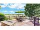 Outdoor dining on the back deck includes a table, umbrella, and fire pit with picturesque views at 14652 Kalamath Ct, Westminster, CO 80023