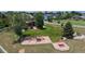 Expansive backyard with lush lawn, play structure, mature trees, and a white fence for added privacy at 14652 Kalamath Ct, Westminster, CO 80023