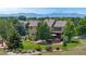Expansive backyard with a deck, play area, manicured lawn, mature trees and mountain views at 14652 Kalamath Ct, Westminster, CO 80023