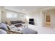 Spacious basement featuring a large sectional sofa, windows, and neutral walls at 14652 Kalamath Ct, Westminster, CO 80023