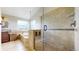 Bright bathroom featuring a soaking tub, a glass-enclosed shower, and neutral tile at 14652 Kalamath Ct, Westminster, CO 80023
