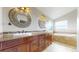 Luxurious primary bathroom with dual sinks, granite countertops, and a jacuzzi tub at 14652 Kalamath Ct, Westminster, CO 80023