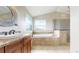 Elegant primary bathroom featuring dual sinks, a large soaking tub, and a walk-in shower at 14652 Kalamath Ct, Westminster, CO 80023