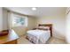 Cozy bedroom featuring a queen-sized bed, a window with blinds, and neutral walls at 14652 Kalamath Ct, Westminster, CO 80023