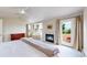 Bright bedroom featuring a fireplace, a cozy seating area and access to an outdoor balcony at 14652 Kalamath Ct, Westminster, CO 80023