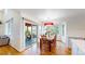 Open concept dining area with wood floors, access to the deck and natural light at 14652 Kalamath Ct, Westminster, CO 80023