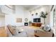 Cozy living room featuring a fireplace, large windows, and comfortable seating arrangements at 14652 Kalamath Ct, Westminster, CO 80023
