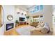 Bright living room with a fireplace, hardwood floors, and large windows with natural light at 14652 Kalamath Ct, Westminster, CO 80023