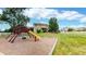 A playground and slide sit on the spacious lawn of this home with mature landscaping and a beautiful lawn at 14652 Kalamath Ct, Westminster, CO 80023